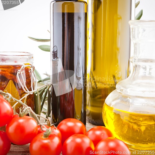 Image of tatsty geen olives tomatoes and olive oil 
