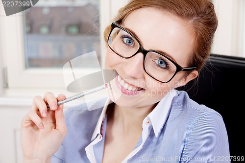 Image of young successful business woman in office