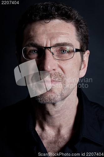 Image of attractive adult man with glasses on black background