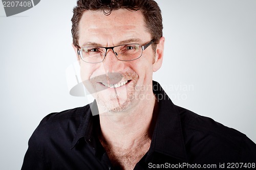 Image of attractive adult man with glasses and black shirt