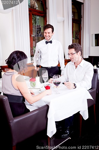 Image of waiter serve fresh espresso for happy couple 