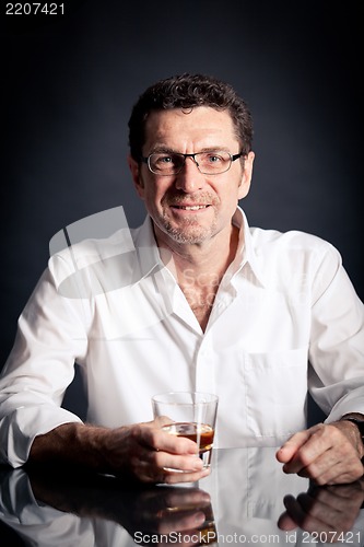 Image of adult man holding an alcoholic drink