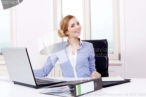 Image of young successful business woman in office