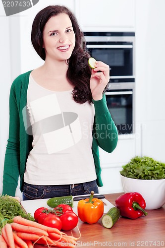 Image of young woman cooking vegetarian food