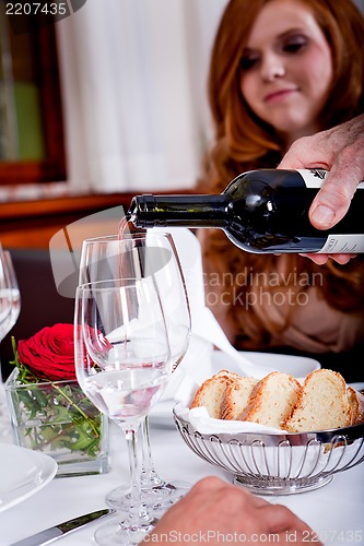 Image of couple drinking red wine in restaurant