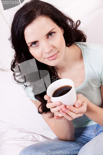 Image of smiling brunette woman drinking black coffee