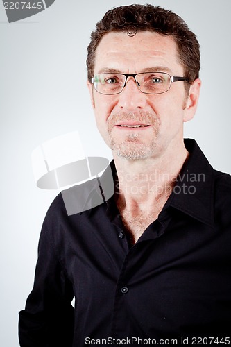 Image of attractive adult man with glasses and black shirt