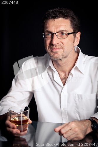 Image of adult man holding an alcoholic drink