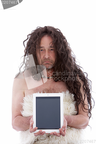 Image of Funny primitive man holding a PC tablet