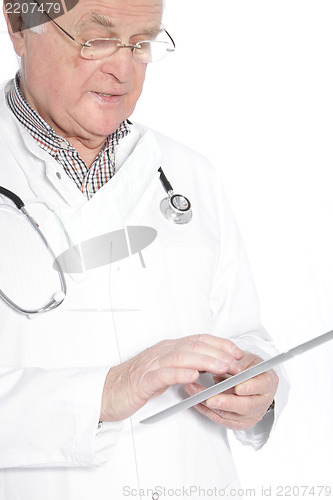 Image of Senior doctor working on a tablet