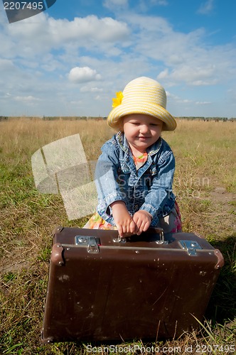 Image of lonely girl with suitcase