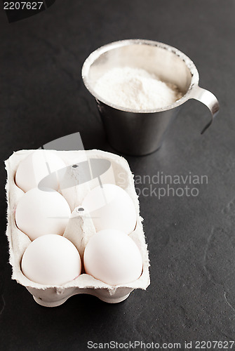 Image of Eggs and cup of flour