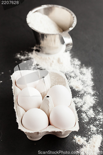 Image of Eggs and cup of flour