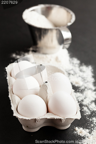 Image of Eggs and cup of flour