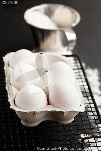 Image of Eggs and cup of flour