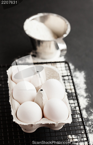 Image of Eggs and cup of flour