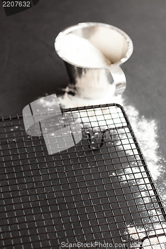 Image of Cup of flour and mesh tray