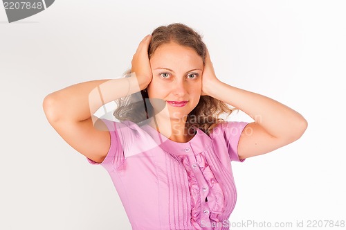 Image of Hear no evil - Young woman covering her ears