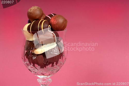 Image of Dark and semi-sweet chocolates in a cut crystal wine glass