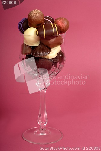 Image of Delicious dark and semi-sweet chocolates in a cut crystal wine g