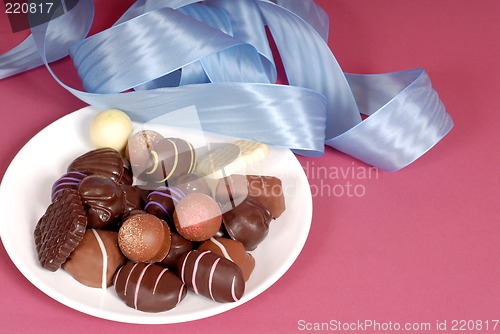 Image of Plate of delicious dark and semi-sweet chocolates with blue ribb