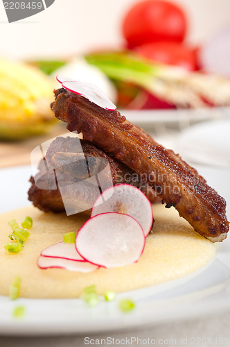 Image of pork ribs on polenta corn cream bed