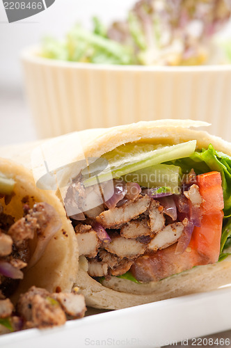 Image of kafta shawarma chicken pita wrap roll sandwich