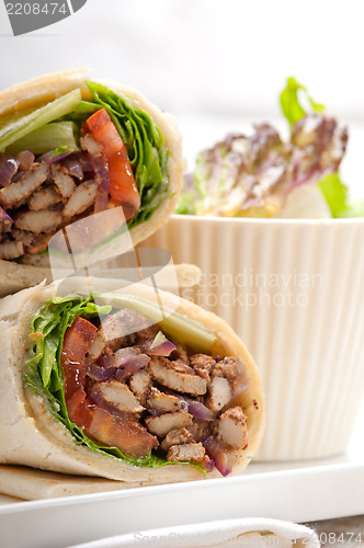 Image of kafta shawarma chicken pita wrap roll sandwich