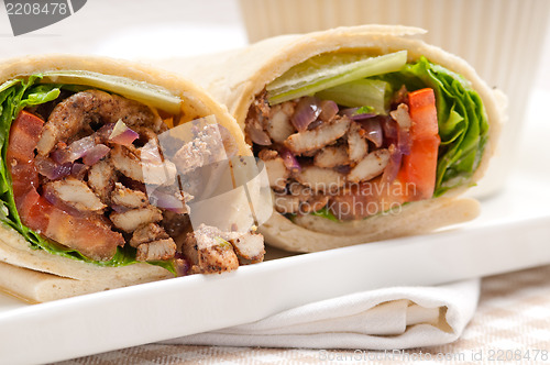 Image of kafta shawarma chicken pita wrap roll sandwich