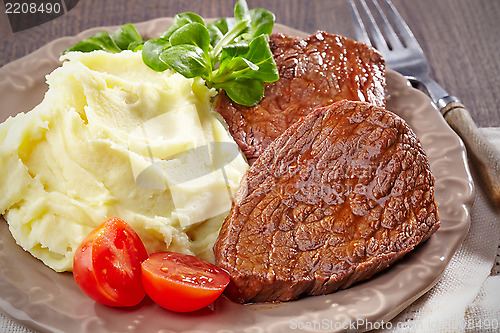 Image of Mashed potatoes and beef steak