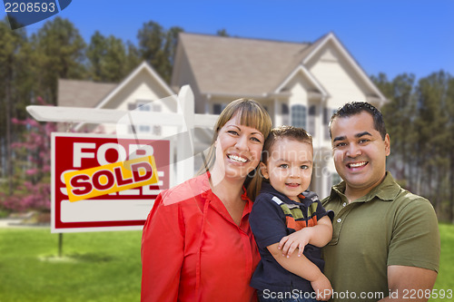 Image of Family in Front of Sold Real Estate Sign and House