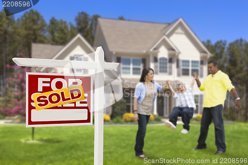 Image of Hispanic Family in Front of Sold Real Estate Sign, House
