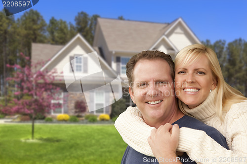 Image of Happy Couple Hugging in Front of House