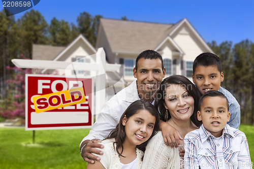 Image of Hispanic Family in Front of Sold Real Estate Sign, House
