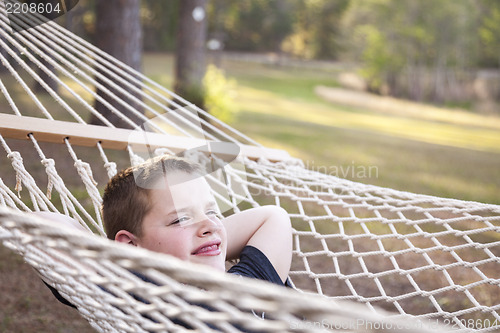 Image of Young Boy Enjoying A Day in His Hammock