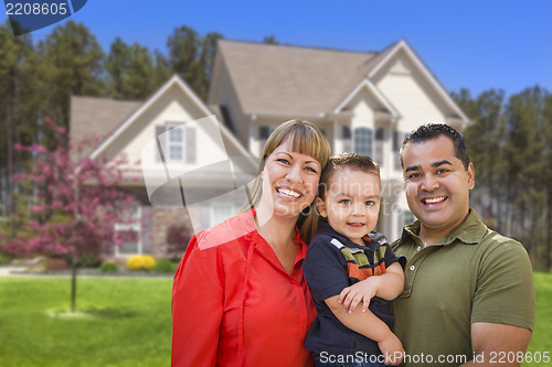 Image of Mixed Race Young Family in Front of House