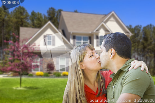 Image of Mixed Race Couple Hugging in Front of House