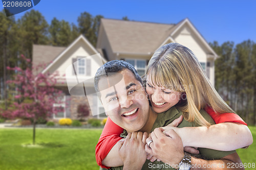 Image of Mixed Race Couple Hugging in Front of House
