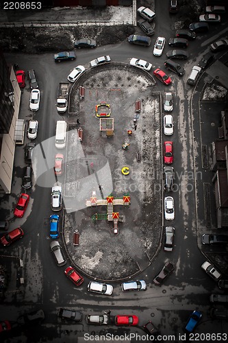 Image of aerial view of city yard with autos