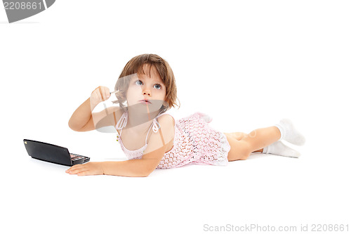 Image of Cute little girl is applying mascara