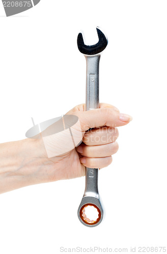 Image of Woman's hand holding a chrome wrench.