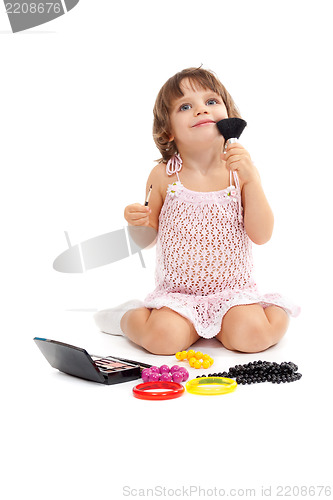 Image of Charming little girl with makeup and colored beads in the studio