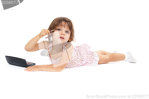 Image of little girl paints the eyelashes mascara