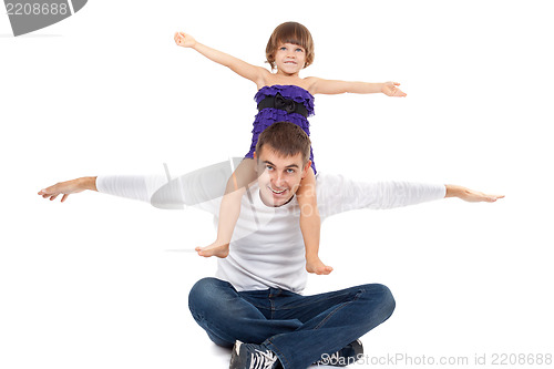 Image of Handsome father with his little daughter on his shoulders happil