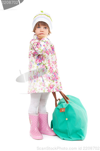 Image of Pretty little girl in autumn clothes with a big bag. Studio port