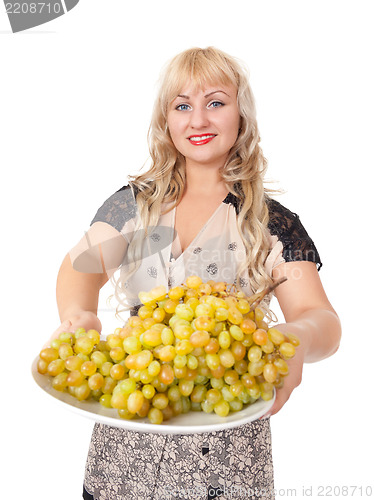 Image of Portrait of attractive young woman holding bowl of grapes