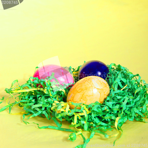 Image of Colourful Easter Eggs on straw