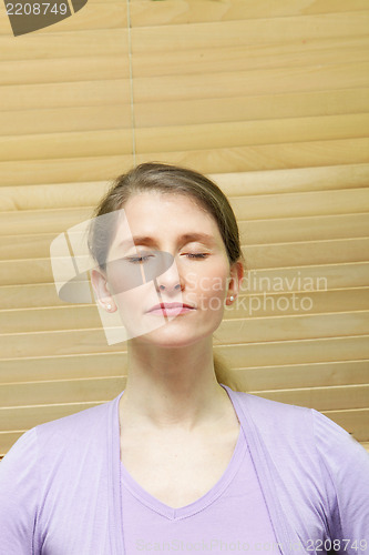 Image of Woman meditating with closed eyes