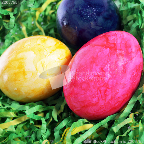 Image of Easter painted eggs in artificial grass