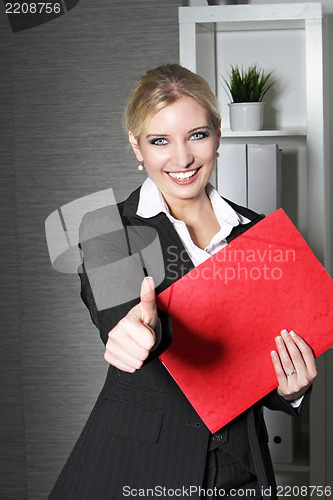 Image of Beautiful office worker giving thumbs up